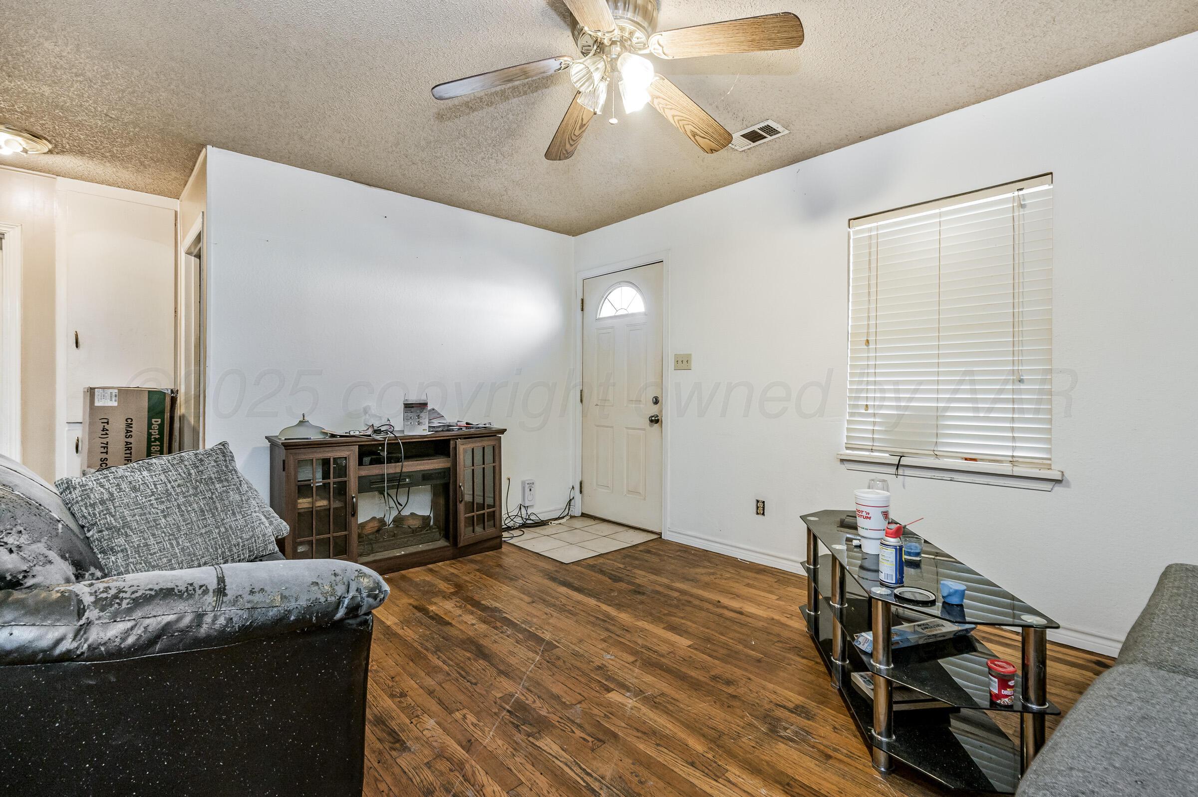 4317 South Polk Street Amarillo, TX 79110 - Photo 4 of 13 a living room with furniture and a fireplace
