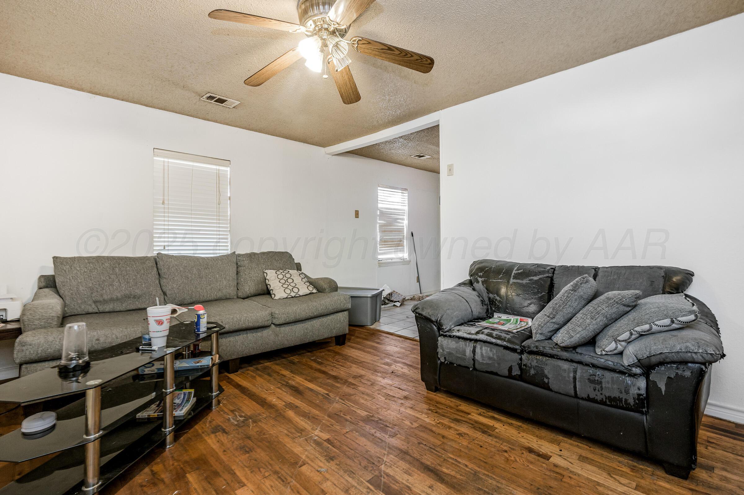 4317 South Polk Street Amarillo, TX 79110 - Photo 5 of 13 a living room with furniture a ceiling fan and a rug