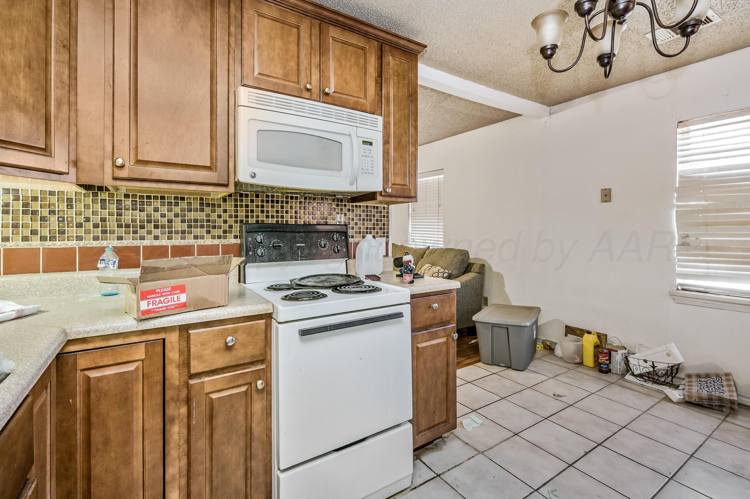 4317 South Polk Street Amarillo, TX 79110 - Photo 8 of 13 a kitchen with a stove and a microwave