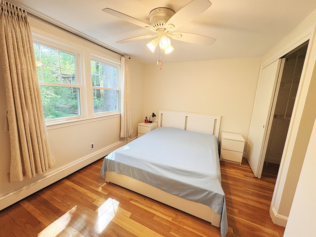 55 Sutherland Road, Unit 55 Arlington, MA 02476 - Photo 8 of 23 a bedroom with a bed and a large window with outer view