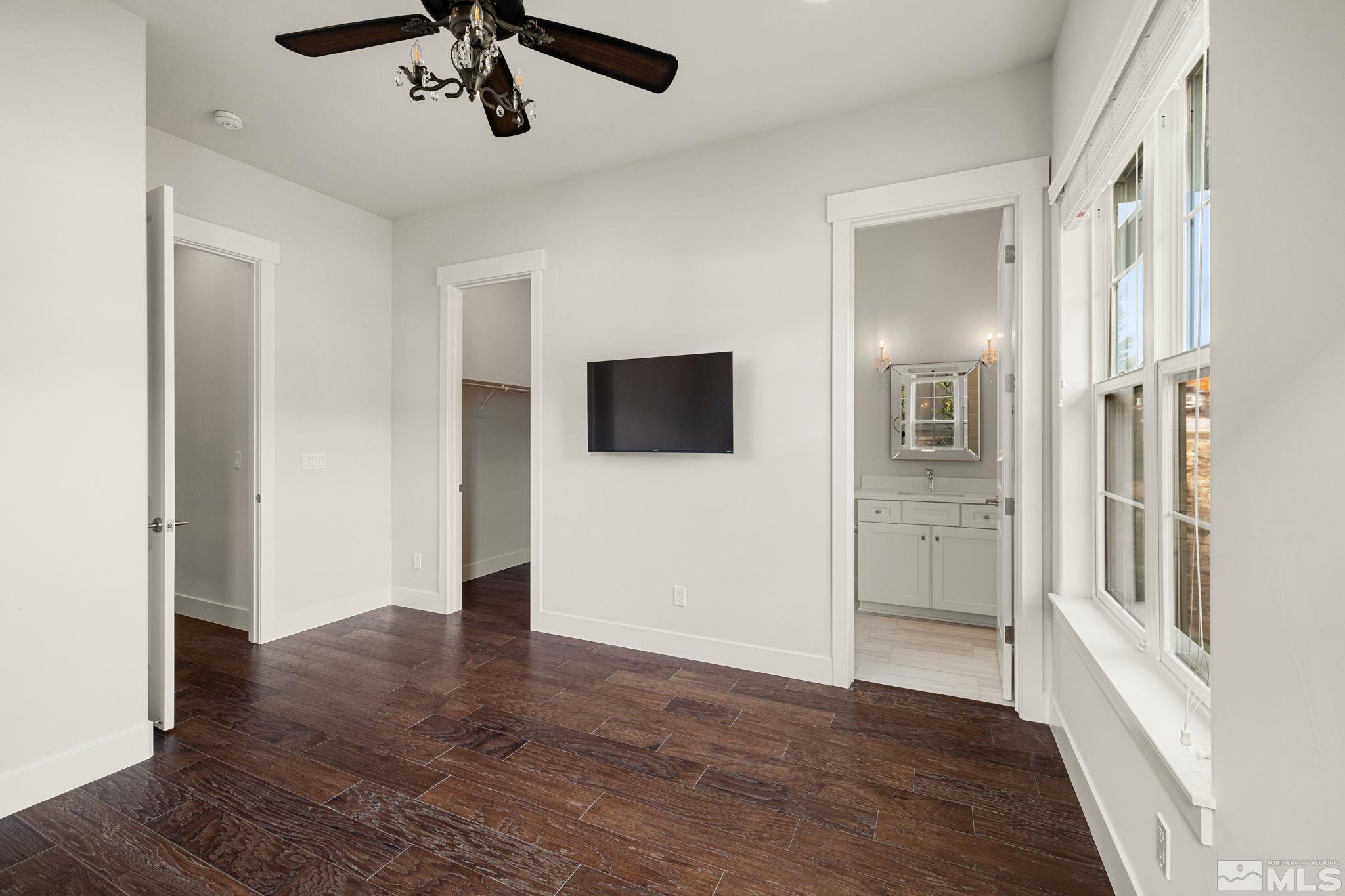 4005 Whispering Pine Loop Reno, NV 89519 - Photo 16 of 39 a view of a livingroom with wooden floor and a ceiling fan
