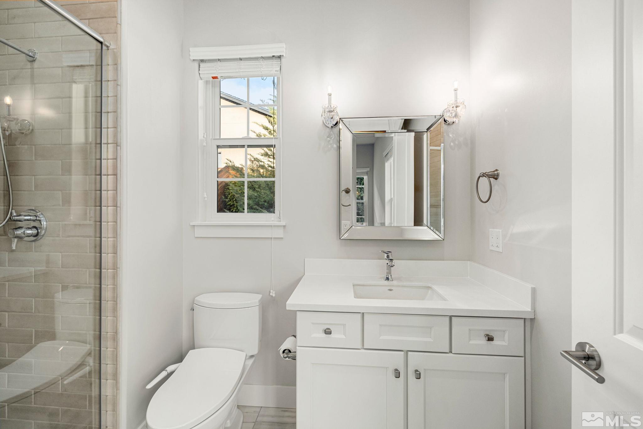 4005 Whispering Pine Loop Reno, NV 89519 - Photo 17 of 39 a bathroom with a toilet a sink and mirror