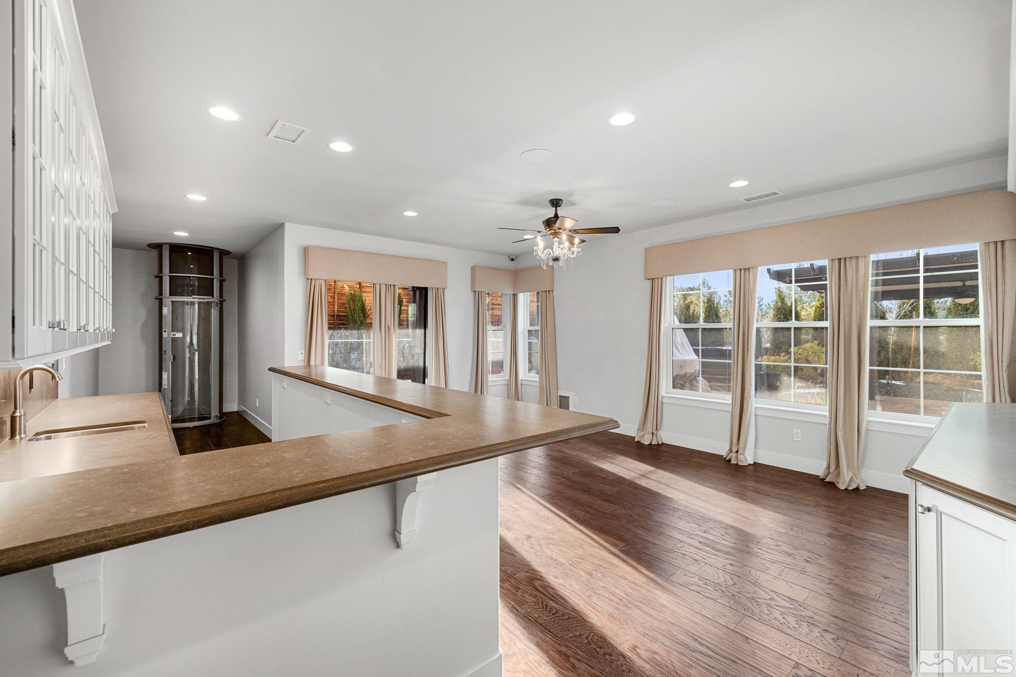 4005 Whispering Pine Loop Reno, NV 89519 - Photo 21 of 39 a large kitchen with granite countertop a large window and a sink