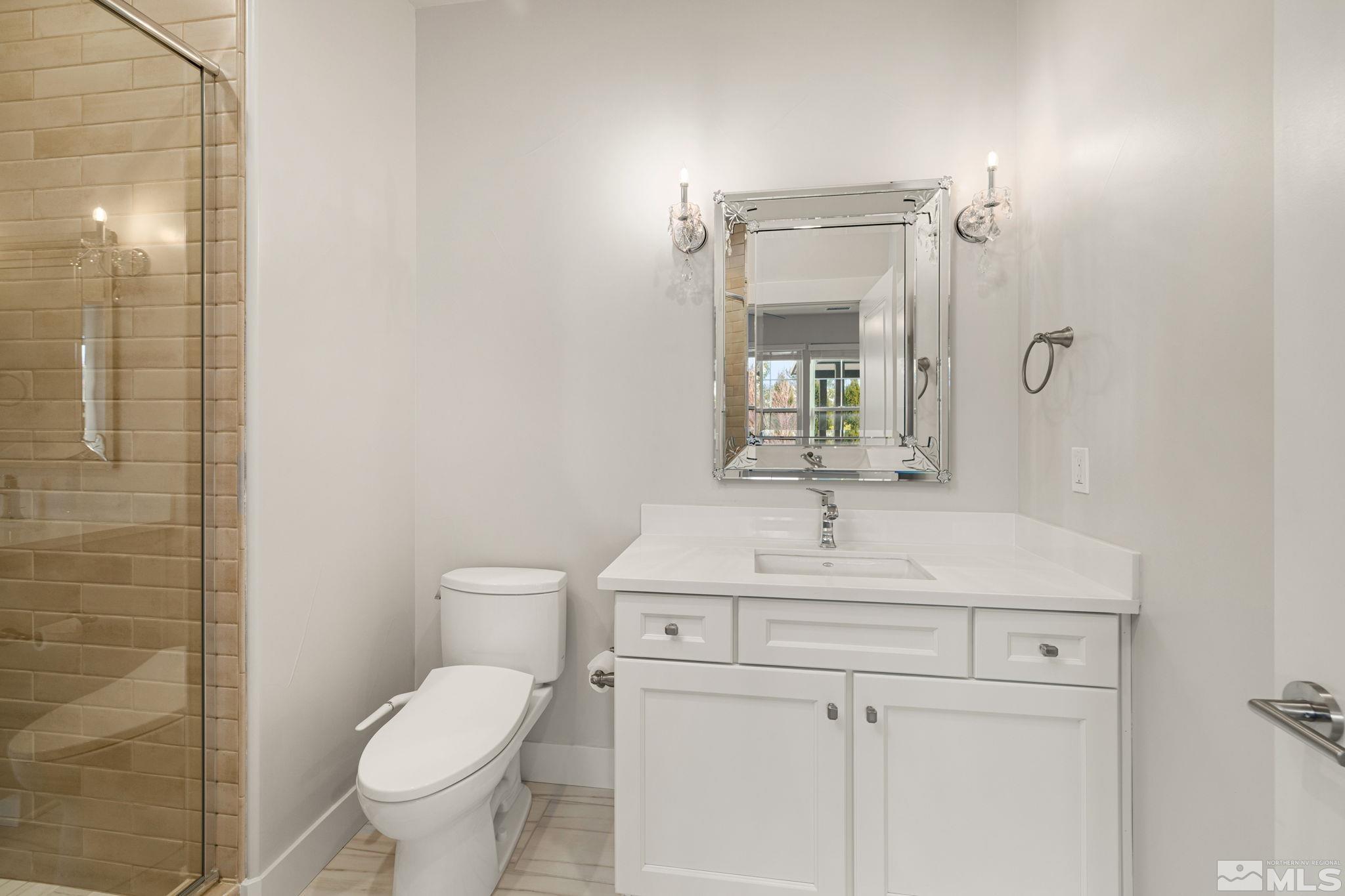 4005 Whispering Pine Loop Reno, NV 89519 - Photo 27 of 39 a bathroom with a sink toilet and mirror