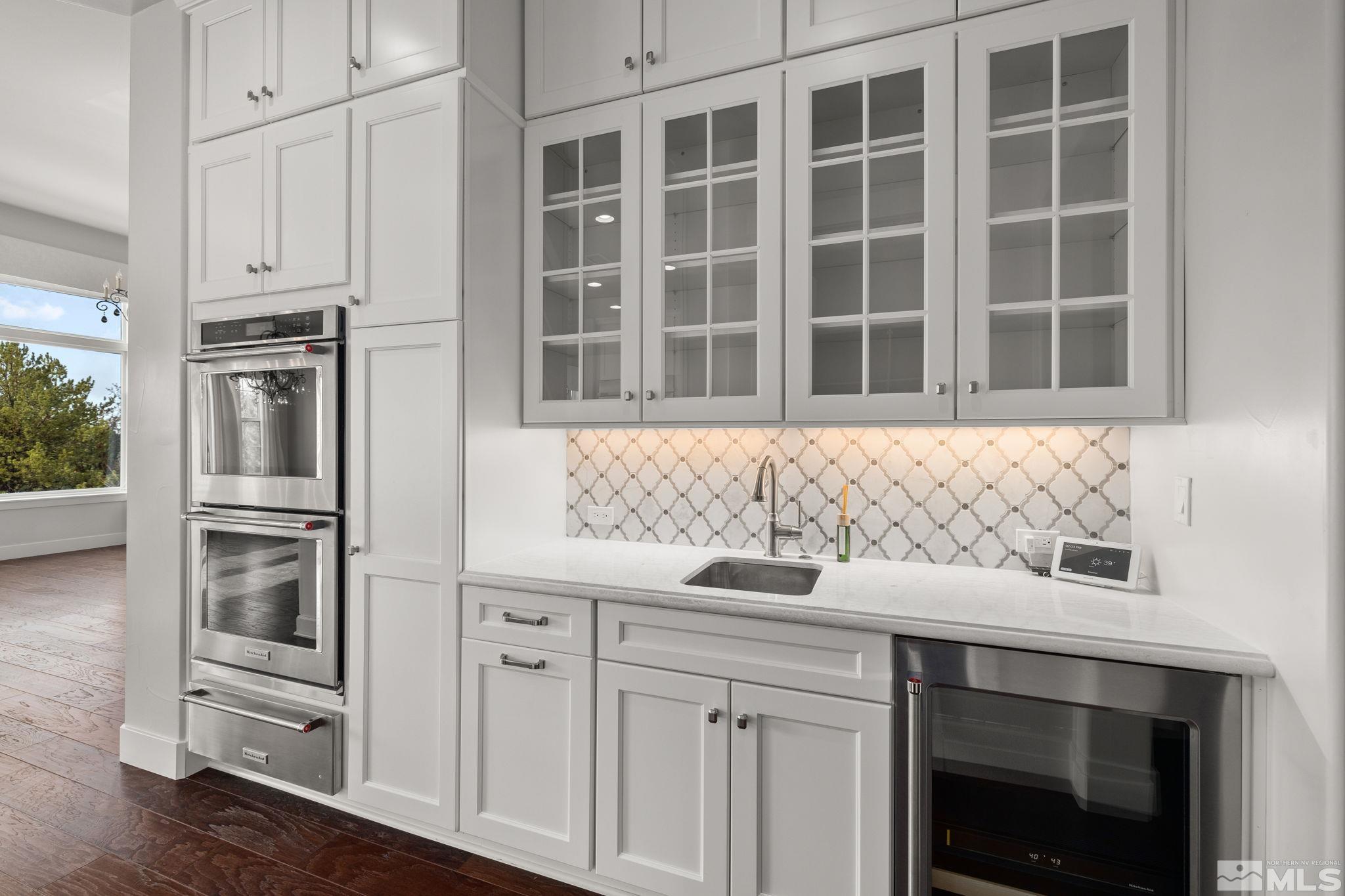 4005 Whispering Pine Loop Reno, NV 89519 - Photo 9 of 39 a kitchen with stainless steel appliances granite countertop a sink and cabinets with wooden floor