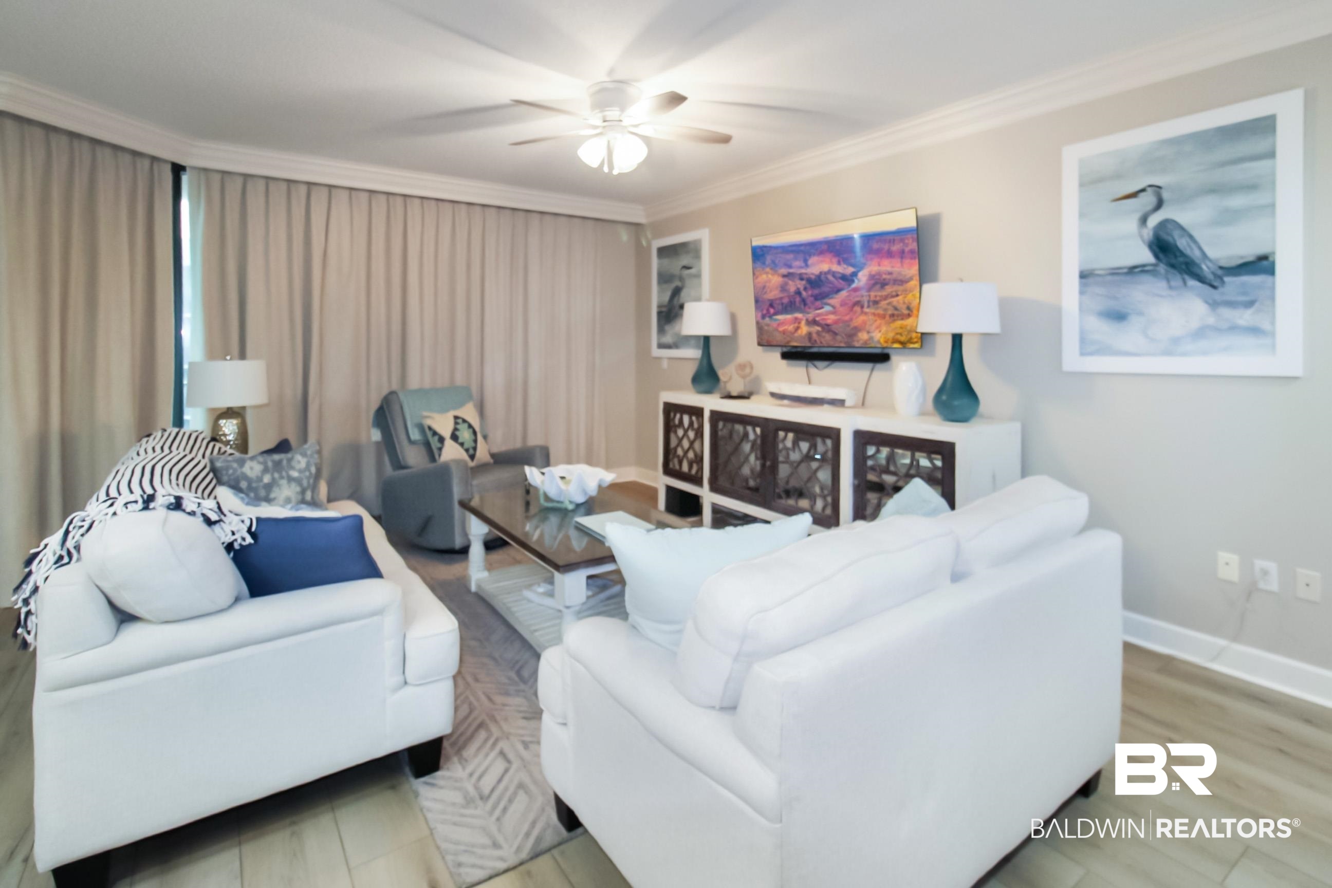 Living area featuring ceiling fan, crown molding, and wood finished floors