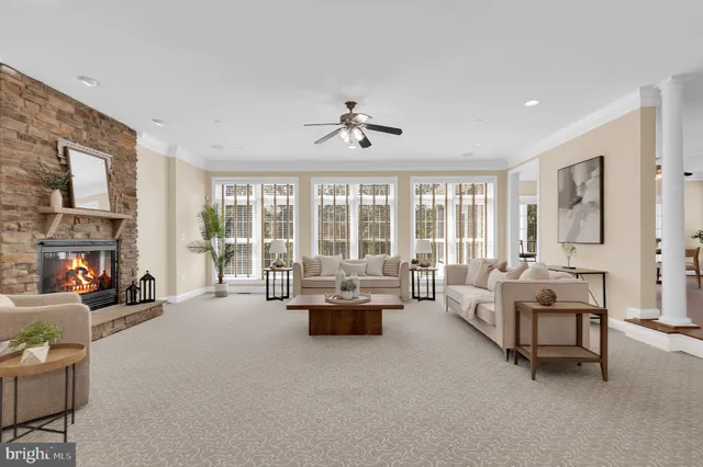 a view of a dining room and livingroom with furniture wooden floor windows