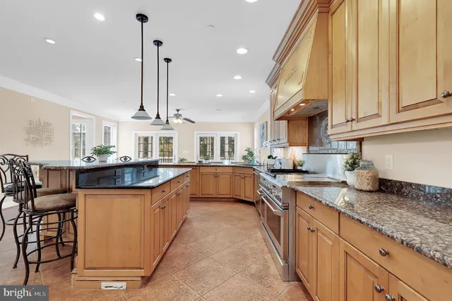 a kitchen with stainless steel appliances granite countertop a sink and cabinets