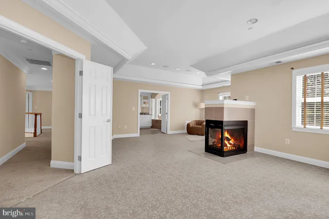 a large white kitchen with granite countertop a sink and dishwasher a stove with wooden floor