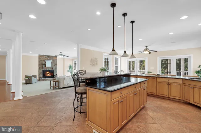 a kitchen with stainless steel appliances granite countertop a sink and a stove top oven