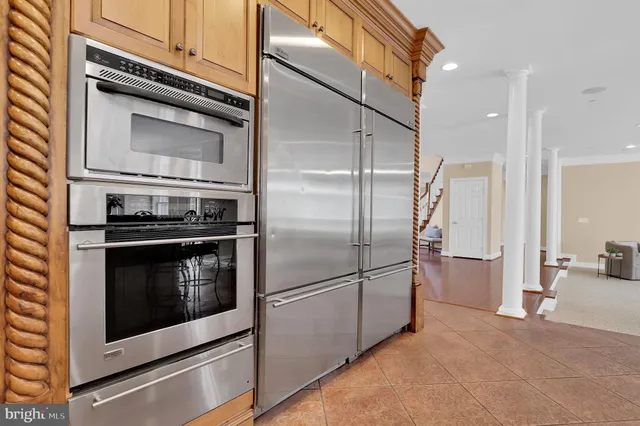 a kitchen with cabinets and chairs