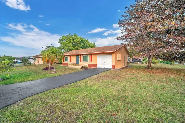 a front view of house with yard and green space