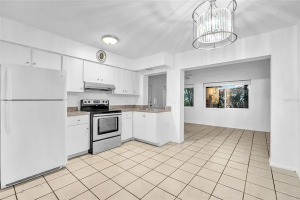 a kitchen with stainless steel appliances granite countertop a sink and a stove