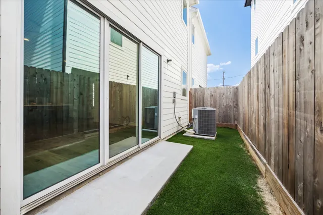 a backyard of a house with table and chairs