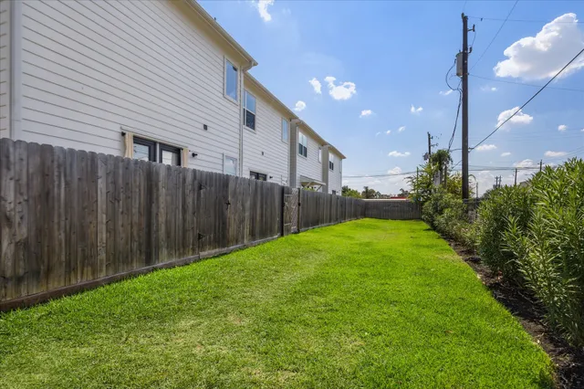 a view of a backyard with wooden fence