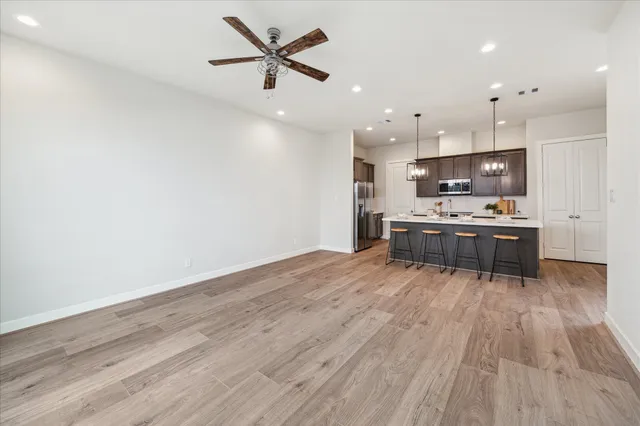 a kitchen with stainless steel appliances a stove top oven a sink and a refrigerator