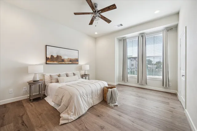 a bedroom with a large bed and a window