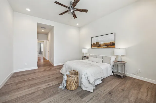a bedroom with a bed and a painting on the wall