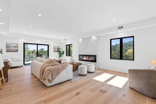 a living room with furniture a rug and a wooden floor