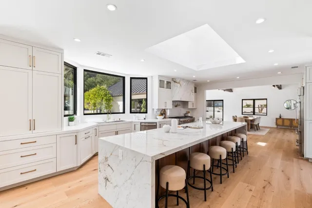 a living room with furniture a flat screen tv and a table