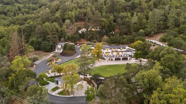 an aerial view of a house with a swimming pool