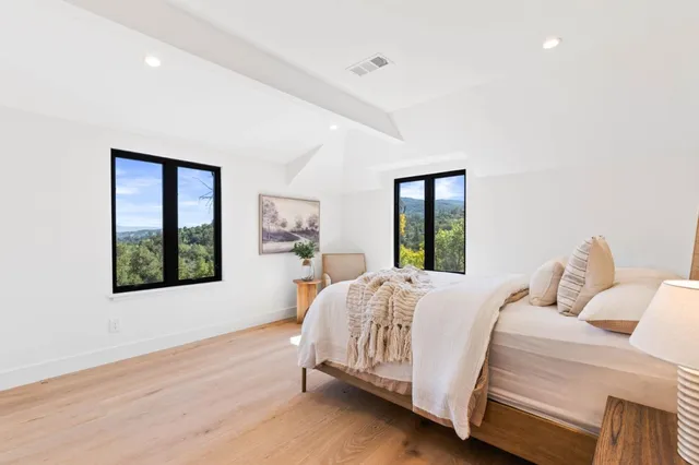 a living room with furniture and a mirror