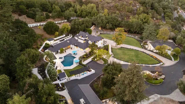 an aerial view of a house with a swimming pool