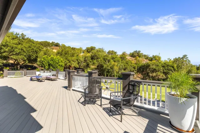 a view of a house with swimming pool and sitting area