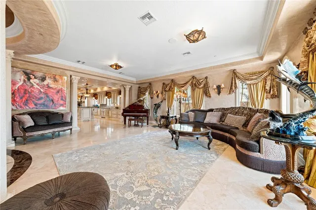 a kitchen with stainless steel appliances kitchen island granite countertop a refrigerator a stove a dining table and chairs with wooden floor