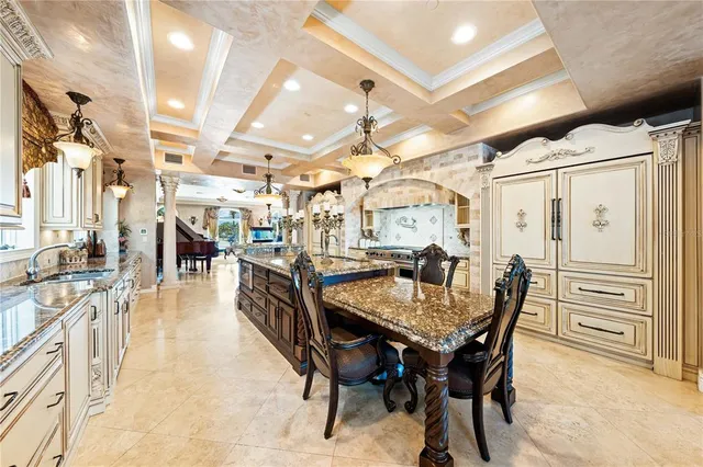 a view of a dining room with furniture and chandelier