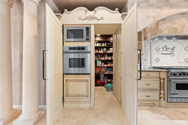 a bedroom with a bed and a mirror on the dresser