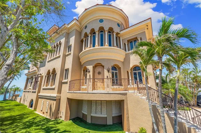 a view of a room with lots of white furniture and a chandelier