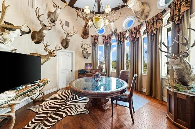 an aerial view of ocean and residential houses with outdoor space