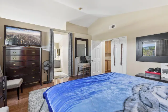 a bedroom with a bed and a dresser