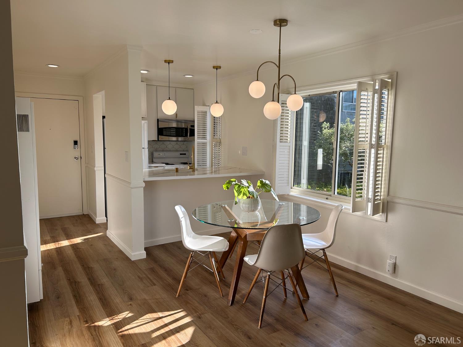 175 Red Rock Way, Unit 101K San Francisco, CA 94131 - Photo 3 of 25 a dining room filled chandelier and wooden floor
