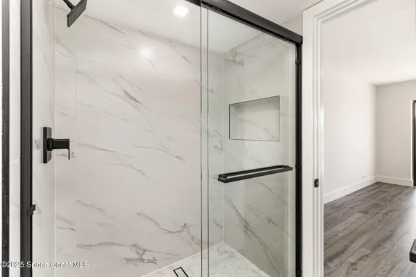 a bathroom with a glass shower door