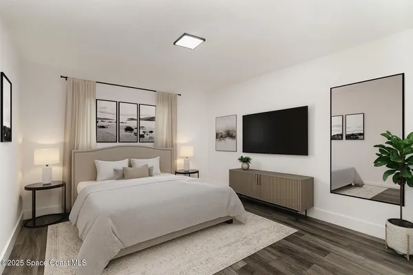 a bedroom with a bed and a flat screen tv