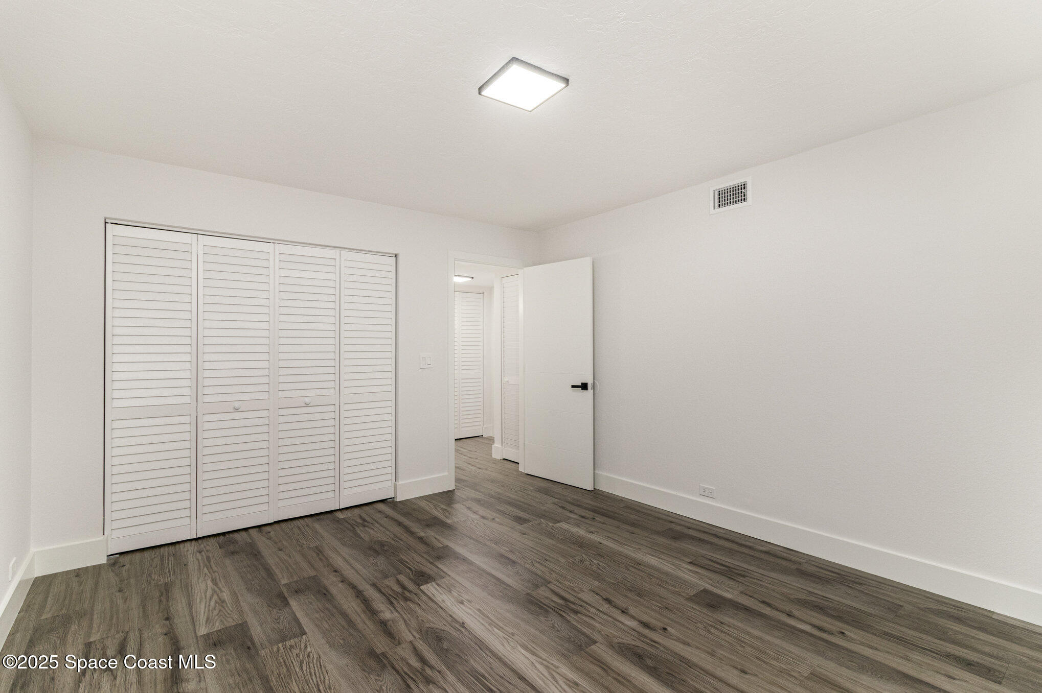 85 South Atlantic Avenue, Unit 306 Cocoa Beach, FL 32931 - Photo 21 of 41 wooden floor in an empty room