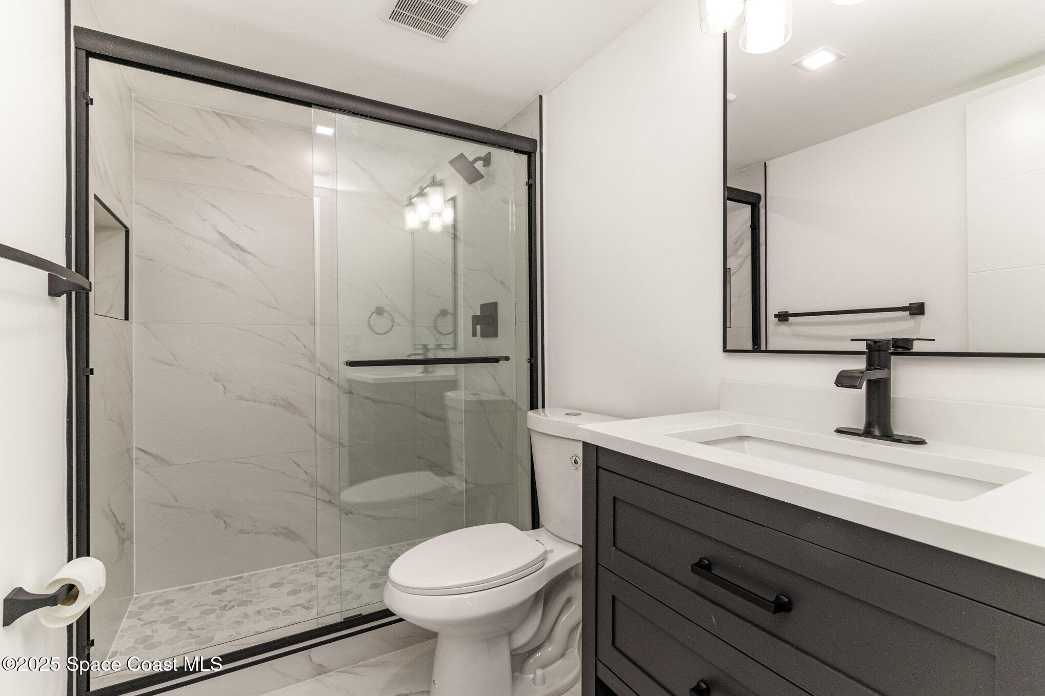 85 South Atlantic Avenue, Unit 306 Cocoa Beach, FL 32931 - Photo 22 of 41 a bathroom with a sink and a mirror