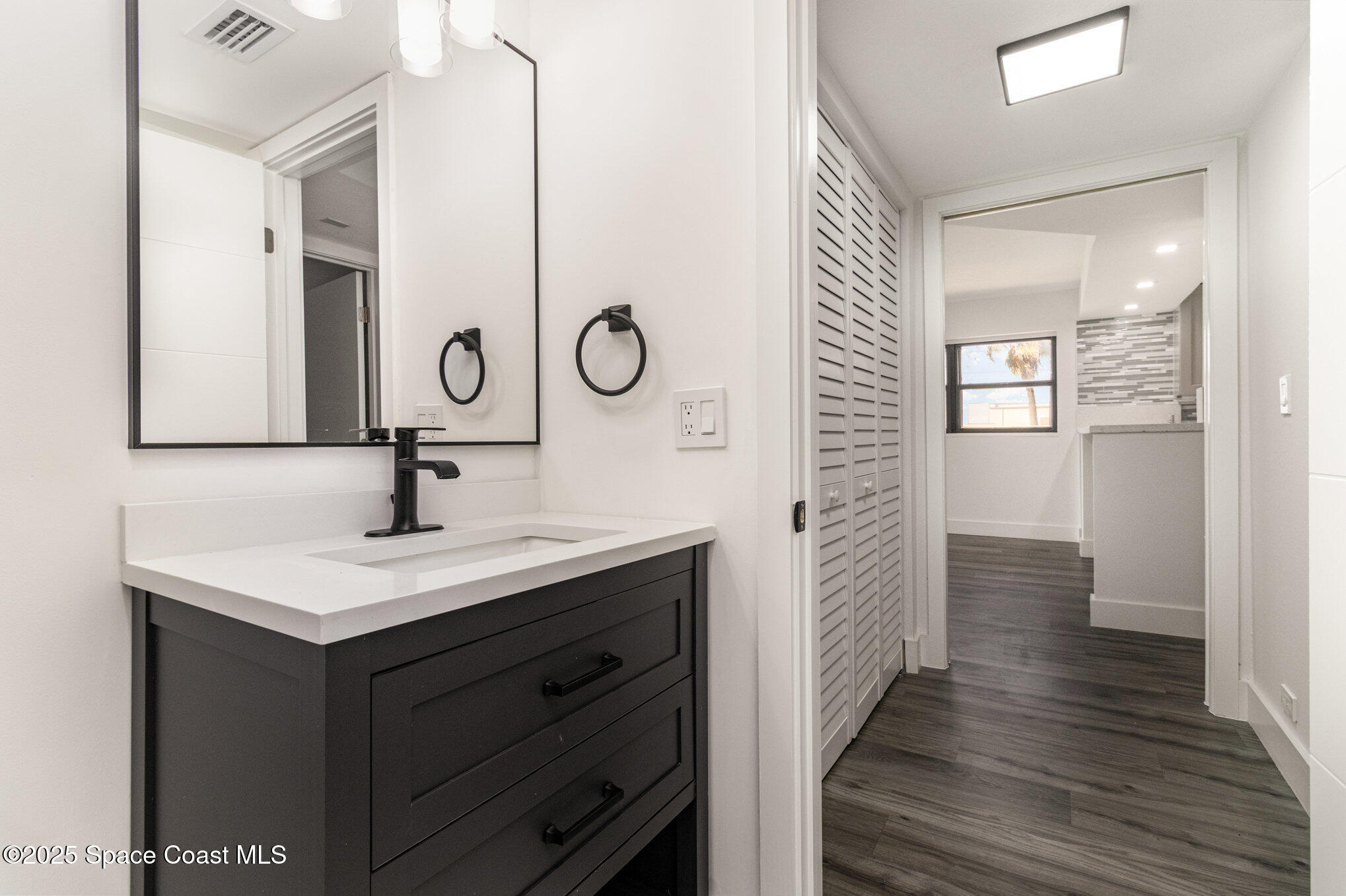 85 South Atlantic Avenue, Unit 306 Cocoa Beach, FL 32931 - Photo 23 of 41 a bathroom with a sink and a mirror