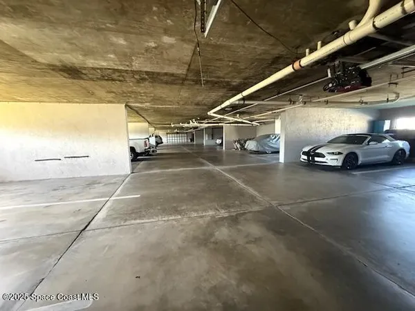 a view of parking garage with cars
