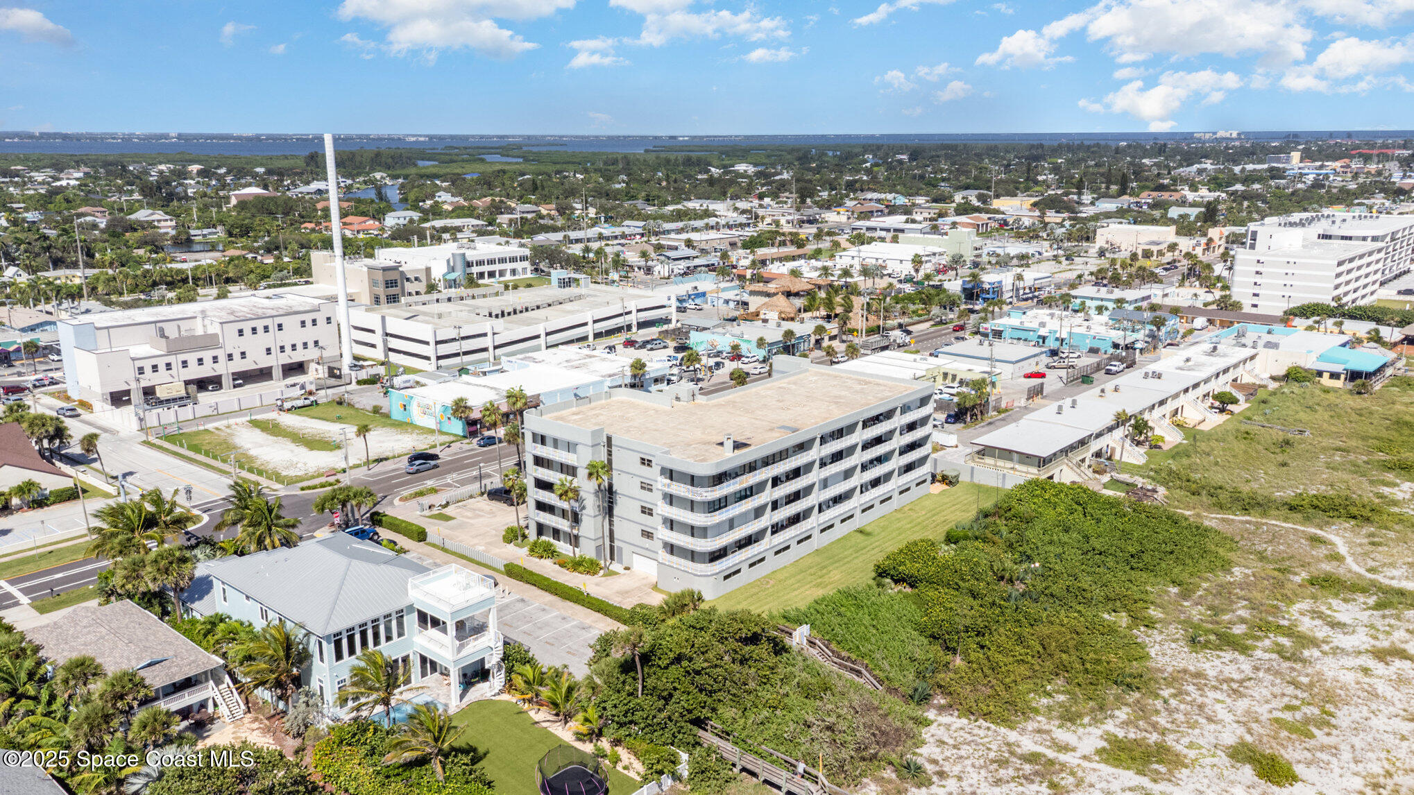 85 South Atlantic Avenue, Unit 306 Cocoa Beach, FL 32931 - Photo 32 of 41 an aerial view of residential houses with outdoor space