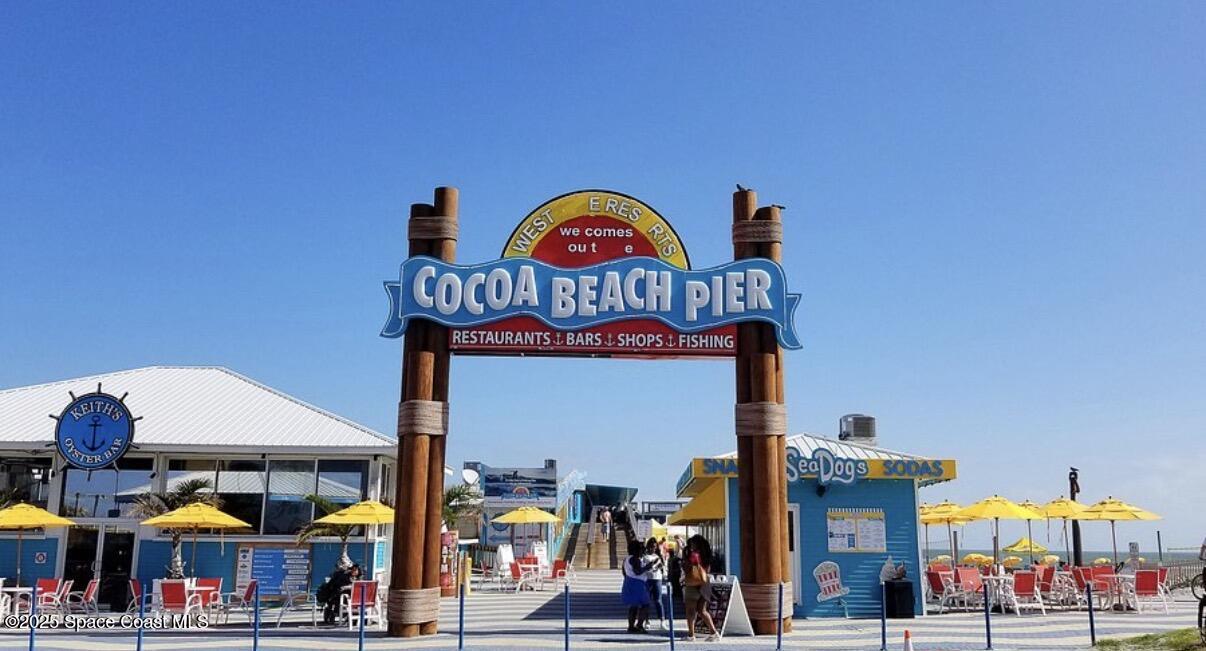 85 South Atlantic Avenue, Unit 306 Cocoa Beach, FL 32931 - Photo 35 of 41 a group of people sitting outside of a area