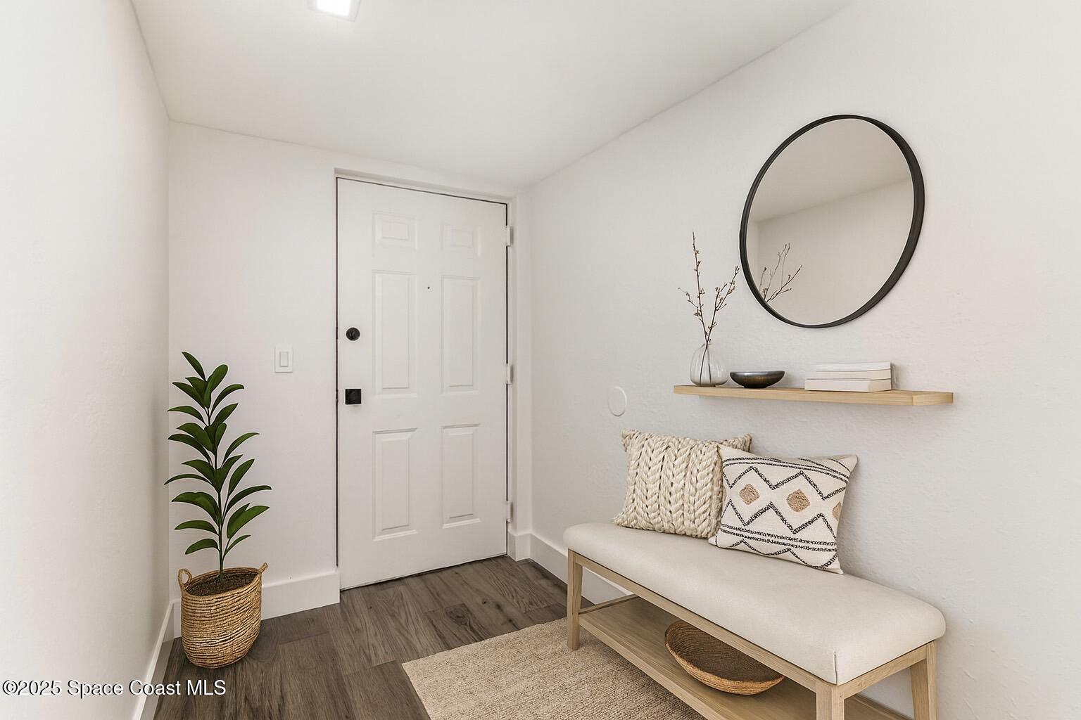 85 South Atlantic Avenue, Unit 306 Cocoa Beach, FL 32931 - Photo 5 of 41 a bathroom with a toilet and a mirror