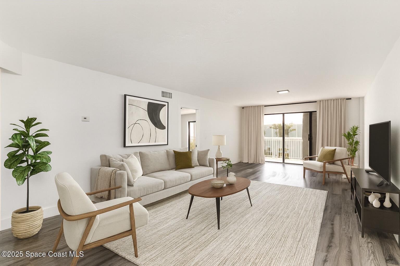 85 South Atlantic Avenue, Unit 306 Cocoa Beach, FL 32931 - Photo 7 of 41 a living room with furniture and a flat screen tv