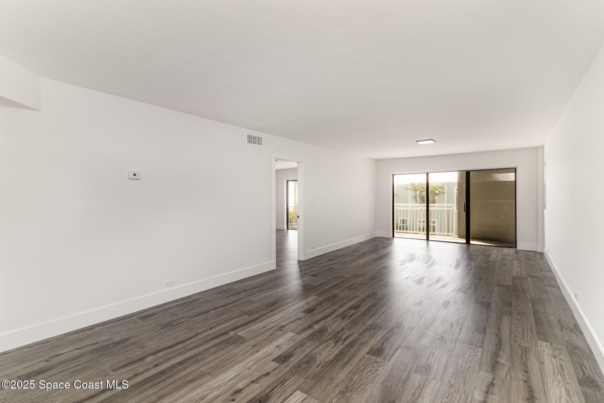 85 South Atlantic Avenue, Unit 306 Cocoa Beach, FL 32931 - Photo 8 of 41 a view of an empty room and wooden floor