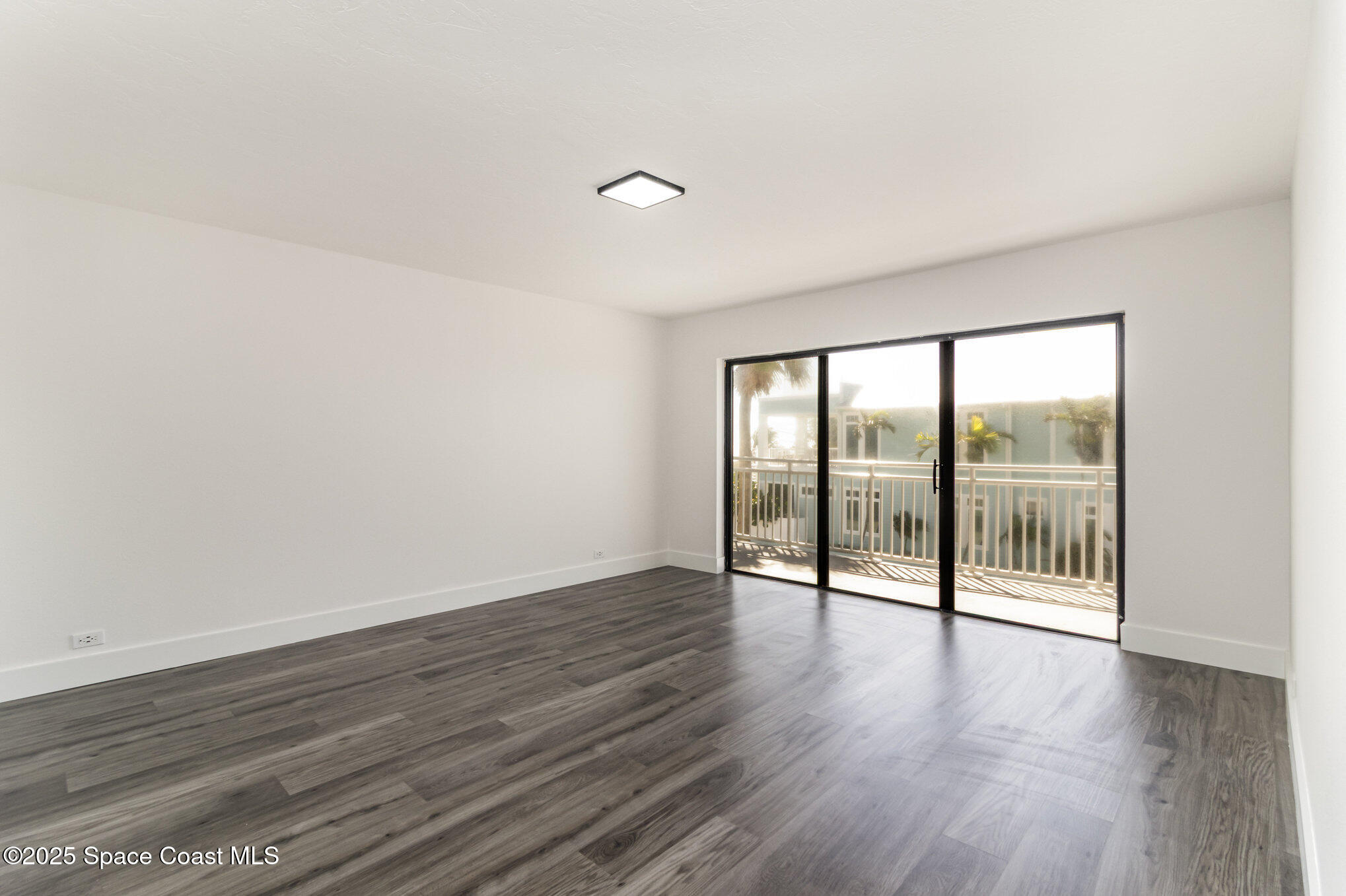 85 South Atlantic Avenue, Unit 306 Cocoa Beach, FL 32931 - Photo 10 of 41 wooden floor in an empty room with a window