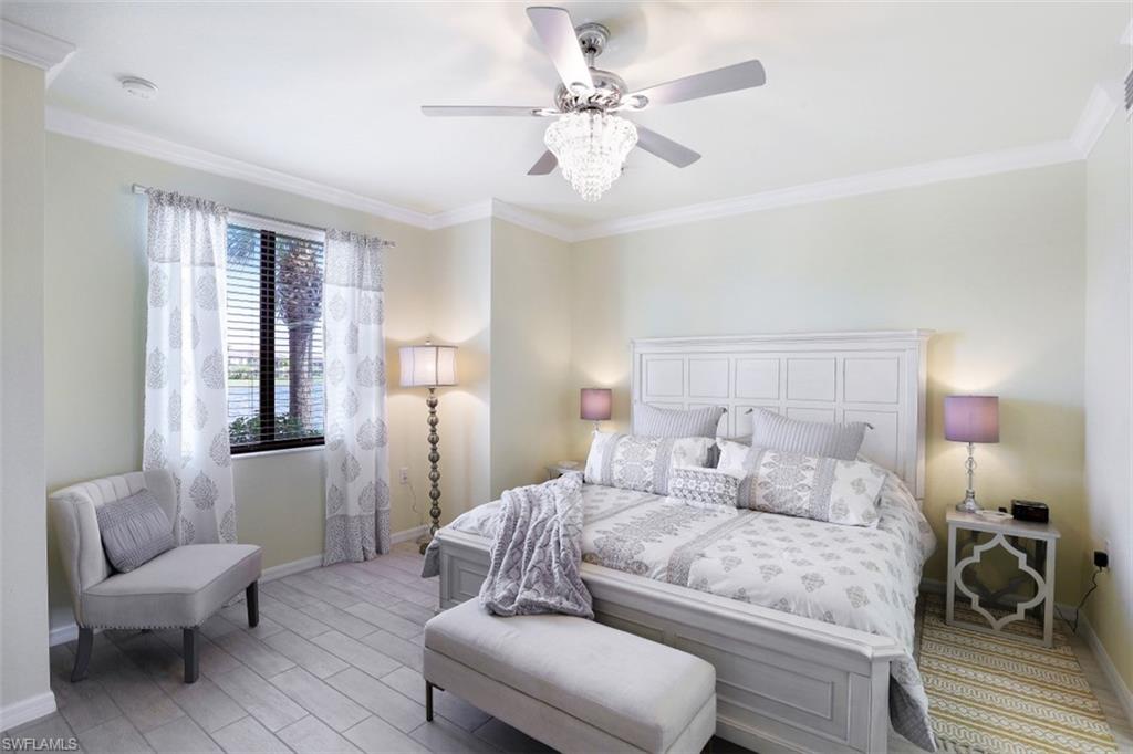 9533 Avellino Way, Unit 2916 Naples, FL 34113 - Photo 13 of 23 a bedroom with a bed and a couch