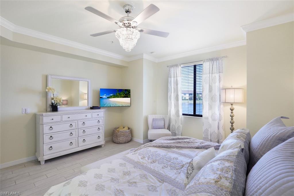 9533 Avellino Way, Unit 2916 Naples, FL 34113 - Photo 14 of 23 a bedroom with a bed and a dresser
