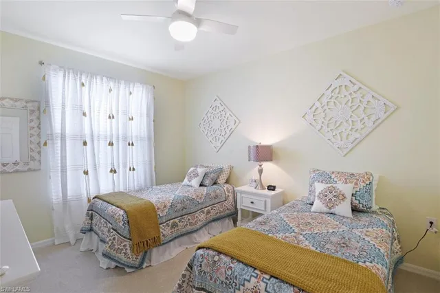 a spacious bedroom with two beds and a chandelier